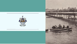 Fully laden boats underneath a crowded Worthing Pier.